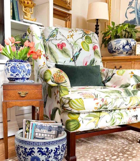 armchair with colorful upholstery in a living room decorated with colorful spring accessories