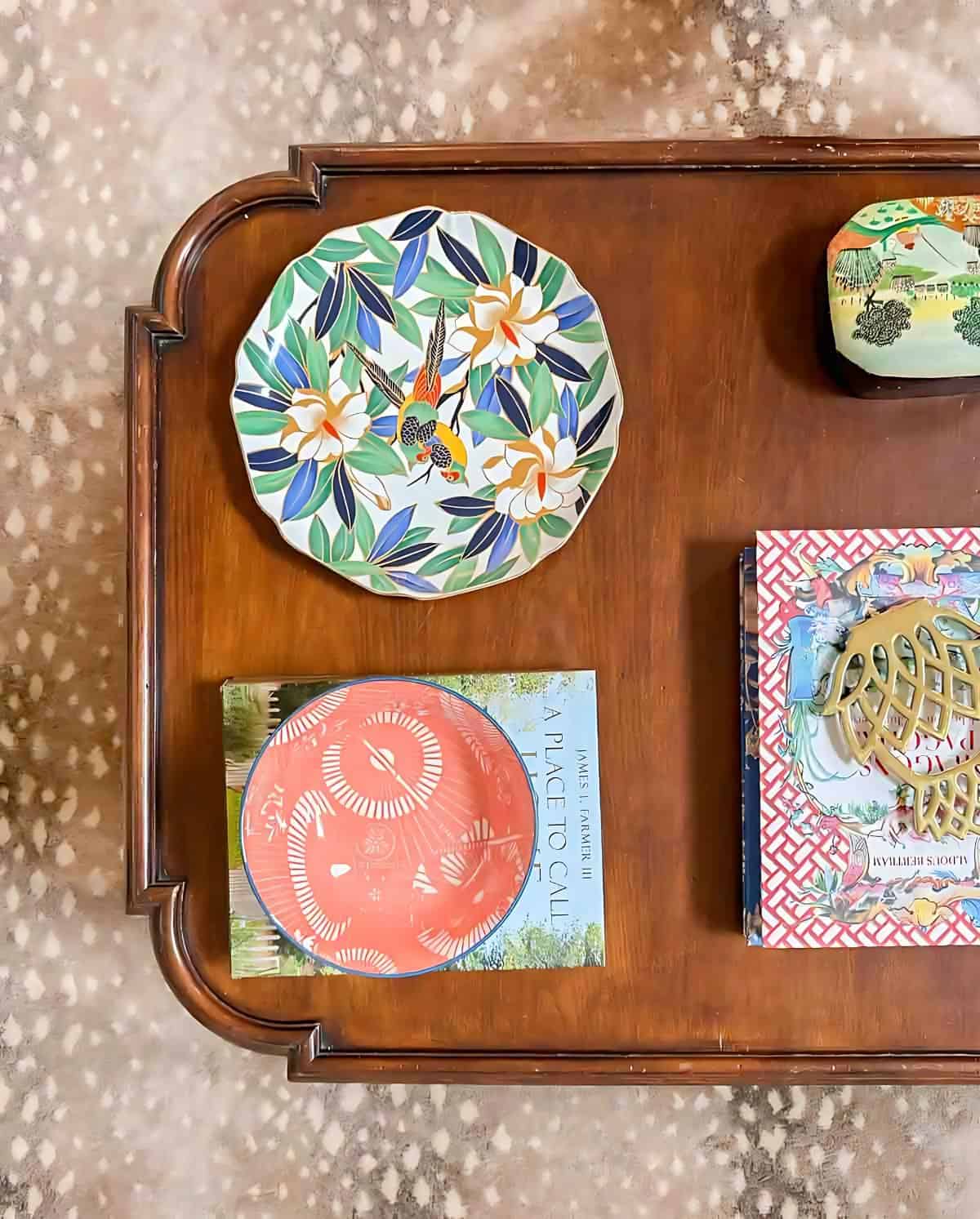 overhead view of a coffee table with chinoiserie accessories on top of an antelope print rug