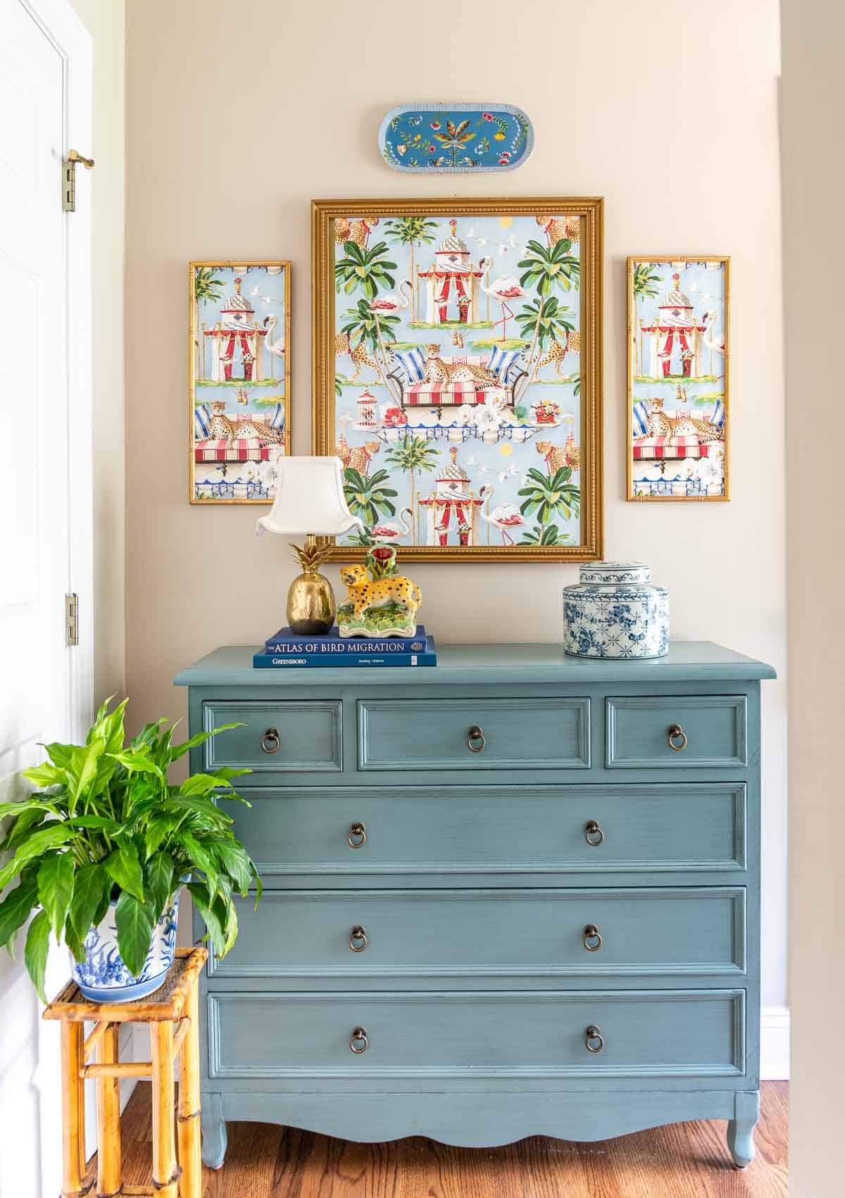 blue accent chest with whimsical art above and chinoiserie accessories