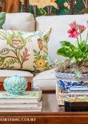 coffee table in front of a beige sofa with summer accessories