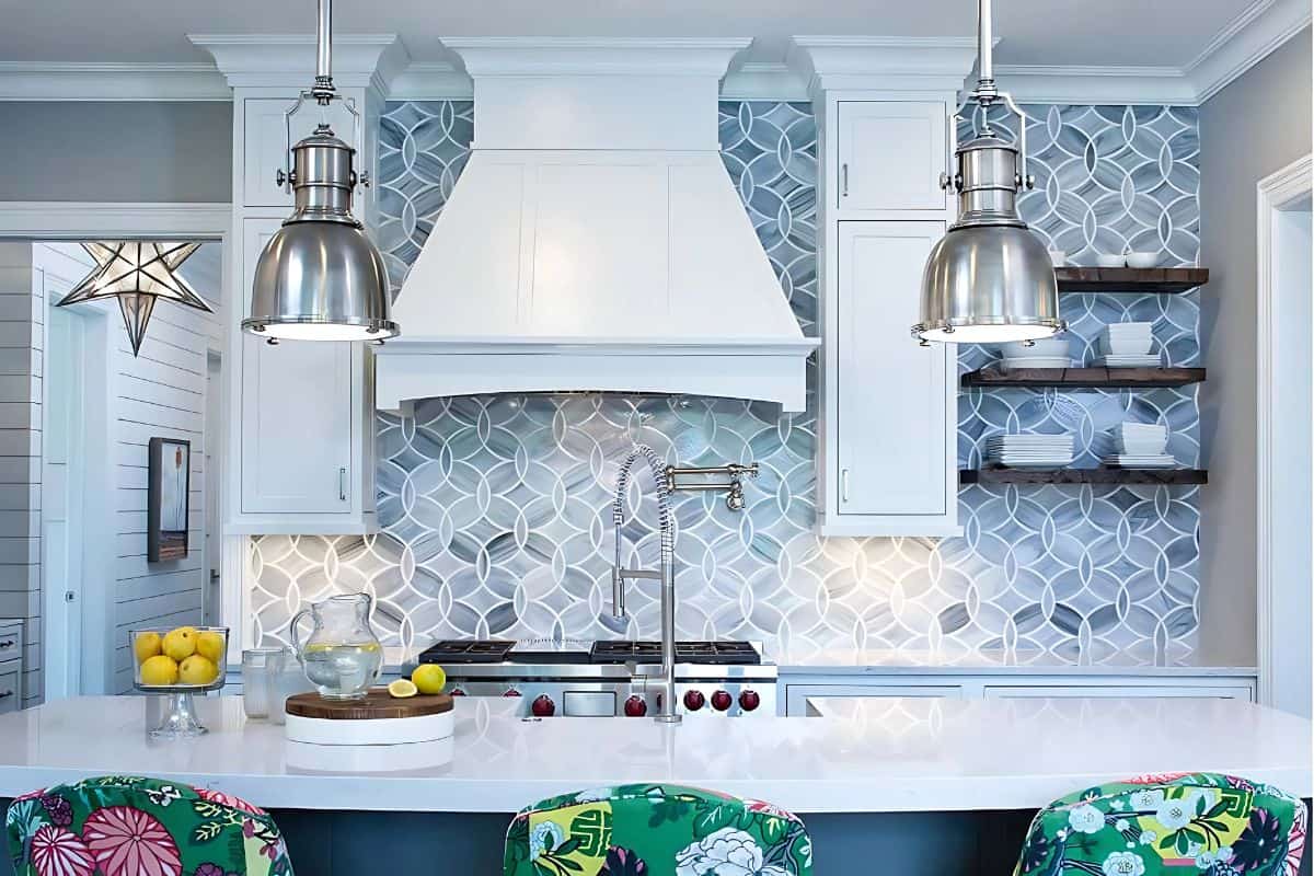 stove wall of a kitchen with white cabinets and a blue and white geometric backsplash