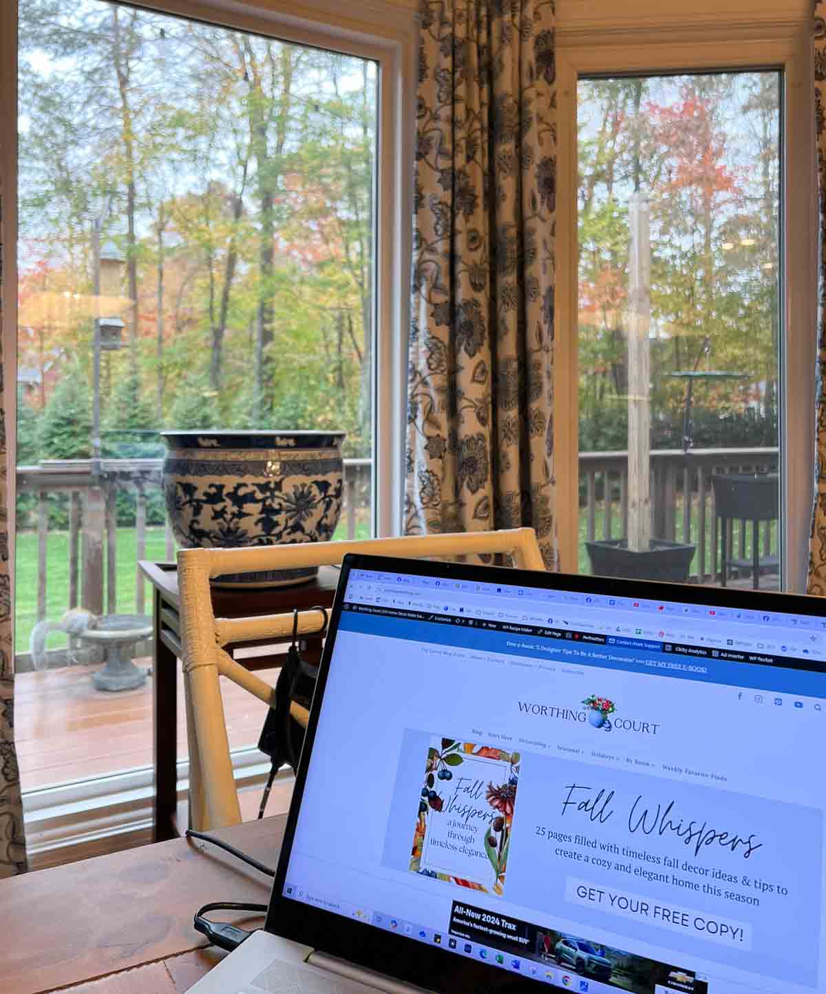 view through a bay window of fall leaves