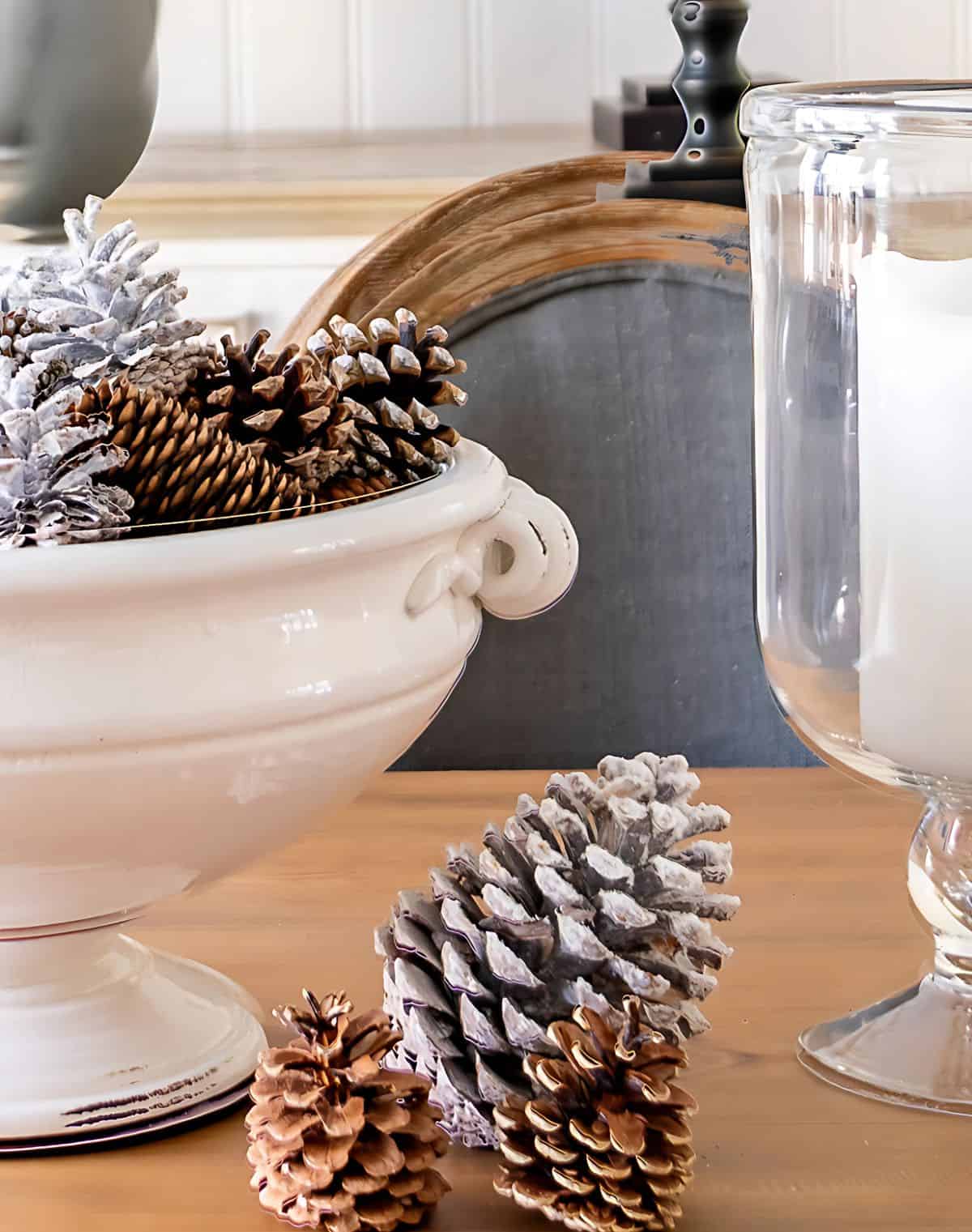 white pedestal bowl filled with snowy pine cones