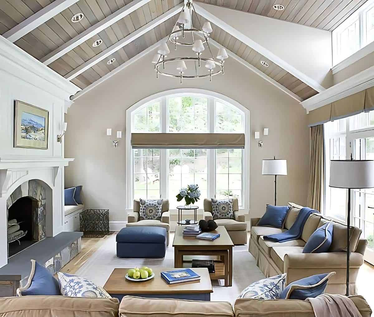 large great room with vaulted ceiling, neutral furniture and blue accents