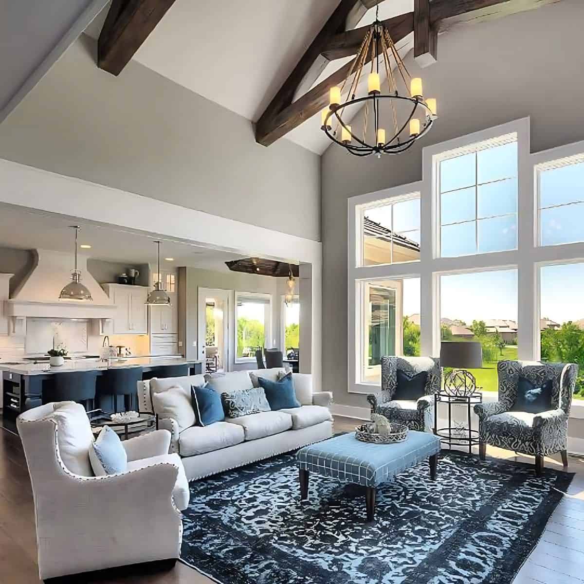 open plan great room with dark blue rug and neutral furnishings