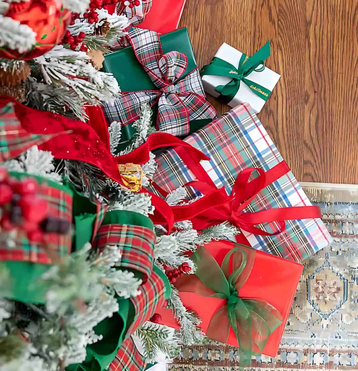 overhead view of wrapped Christmas gifts underneath a tree