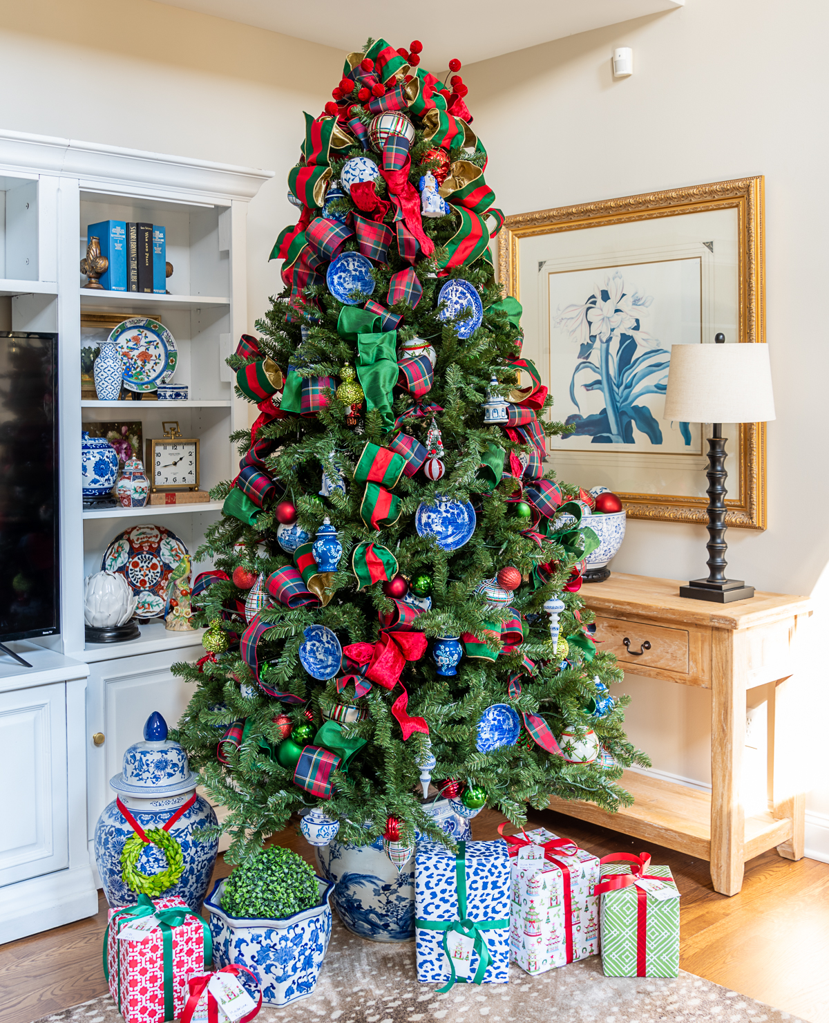 Christmas tree decorated with traditional red and green ribbon and ornaments