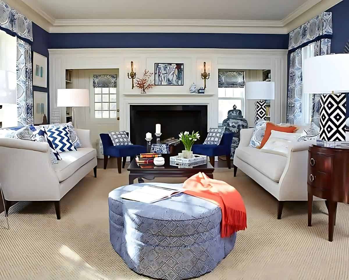 living room with blue walls, blue accessories and a pair of neutral sofas facing one another