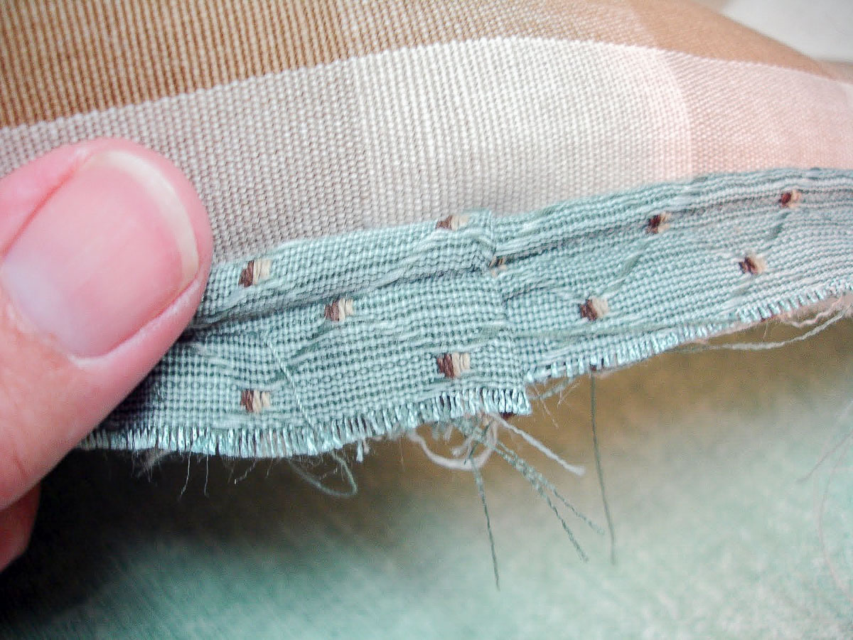blue covered cording being applied to the right side of the fabric for a pillow sham
