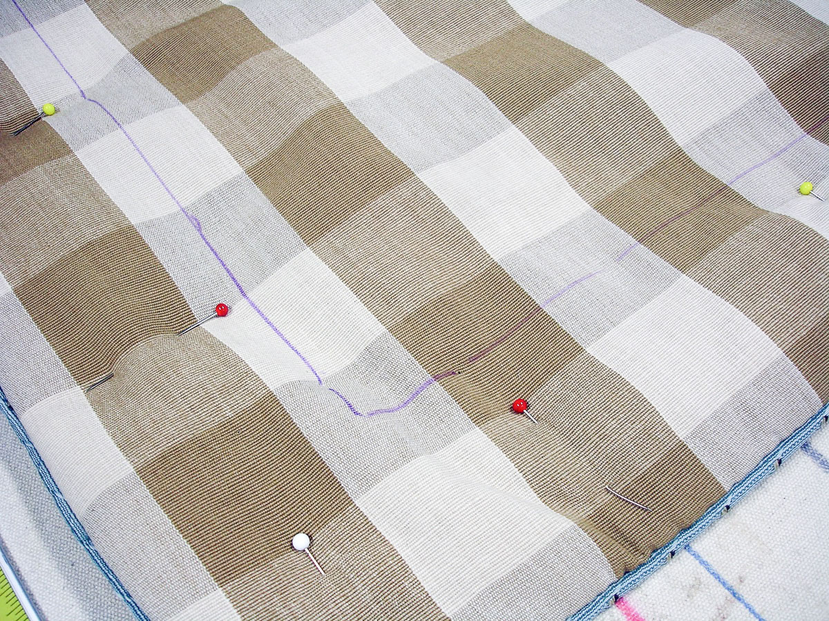 sewing line drawn with disappearing ink on brown and tan check fabric