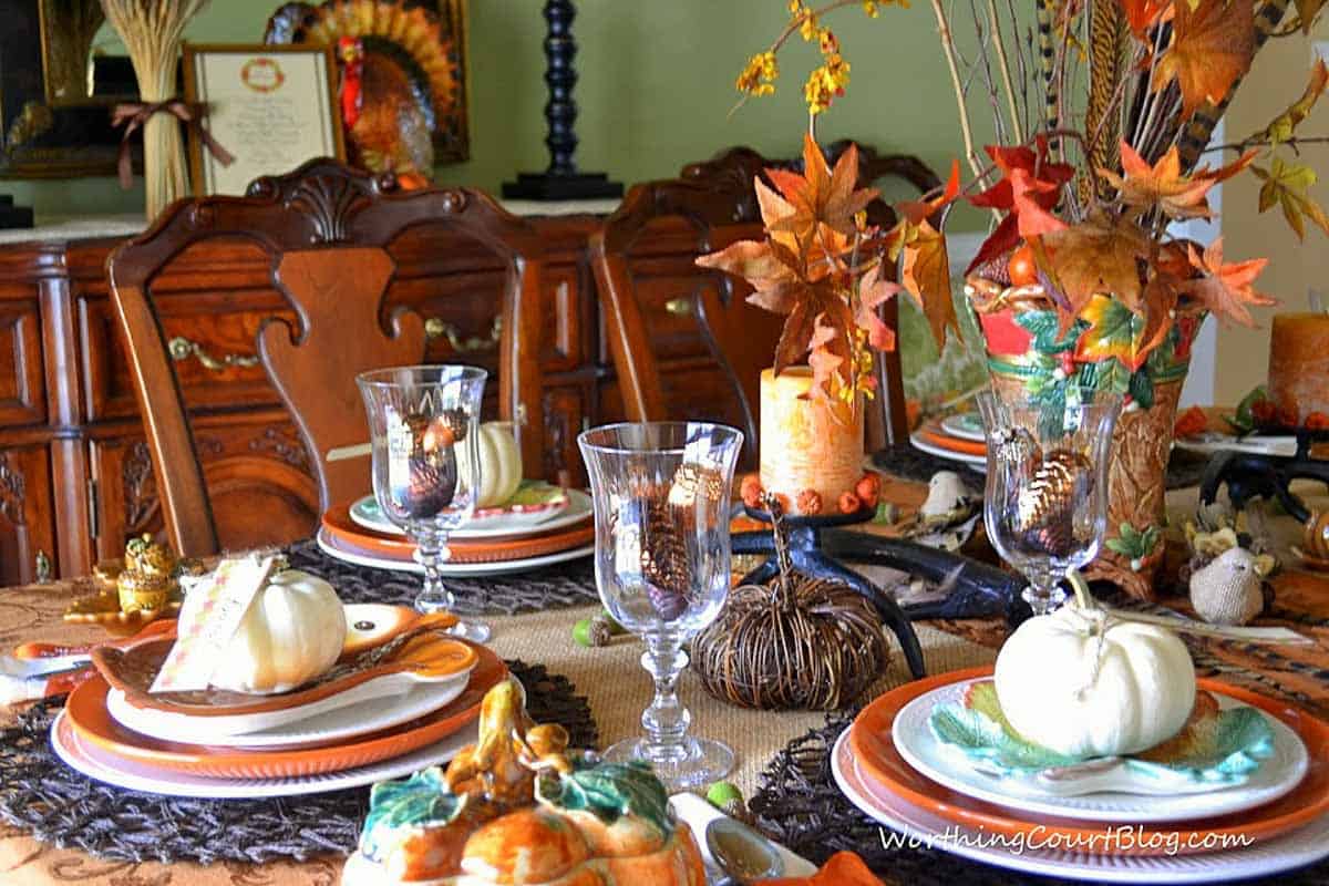 bountiful thanksgiving tablescape set with a variety of fall and traditional thanksgiving colors and elements