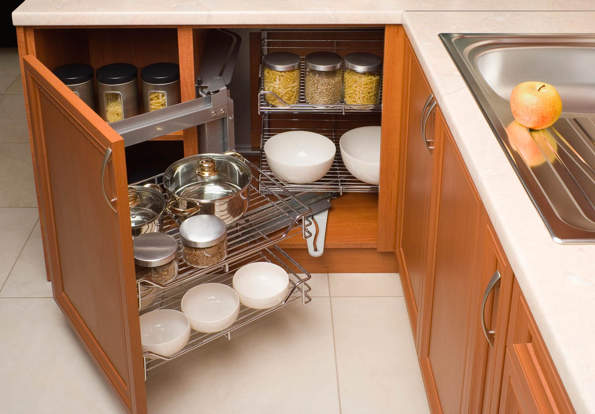 a corner kitchen cabinet organizer inside a wood cabinet