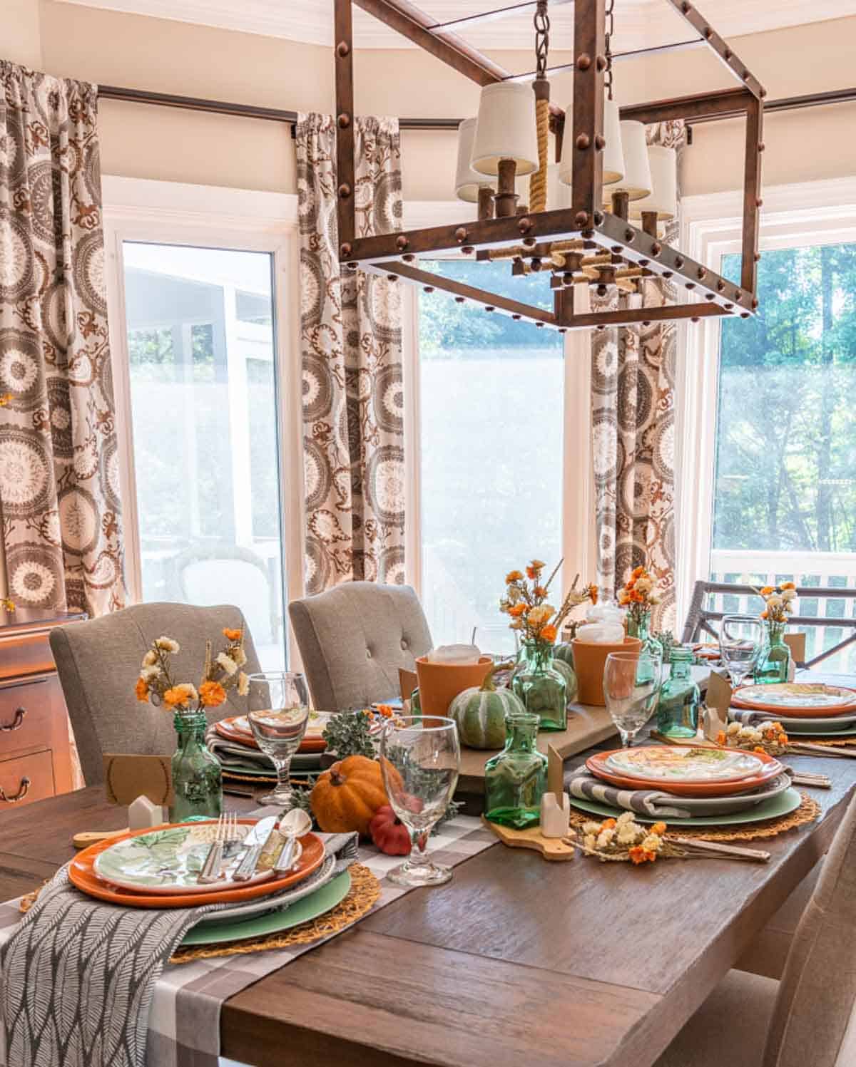 Table set for Thanksgiving with traditional fall colors and aqua as an accent color