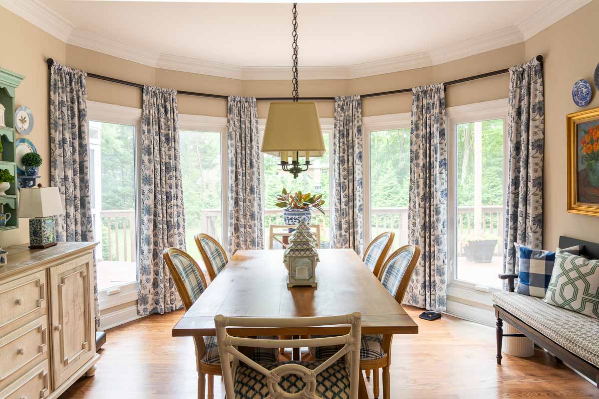 large floor to ceiling bay window in a breakfast room decorated with blue and white