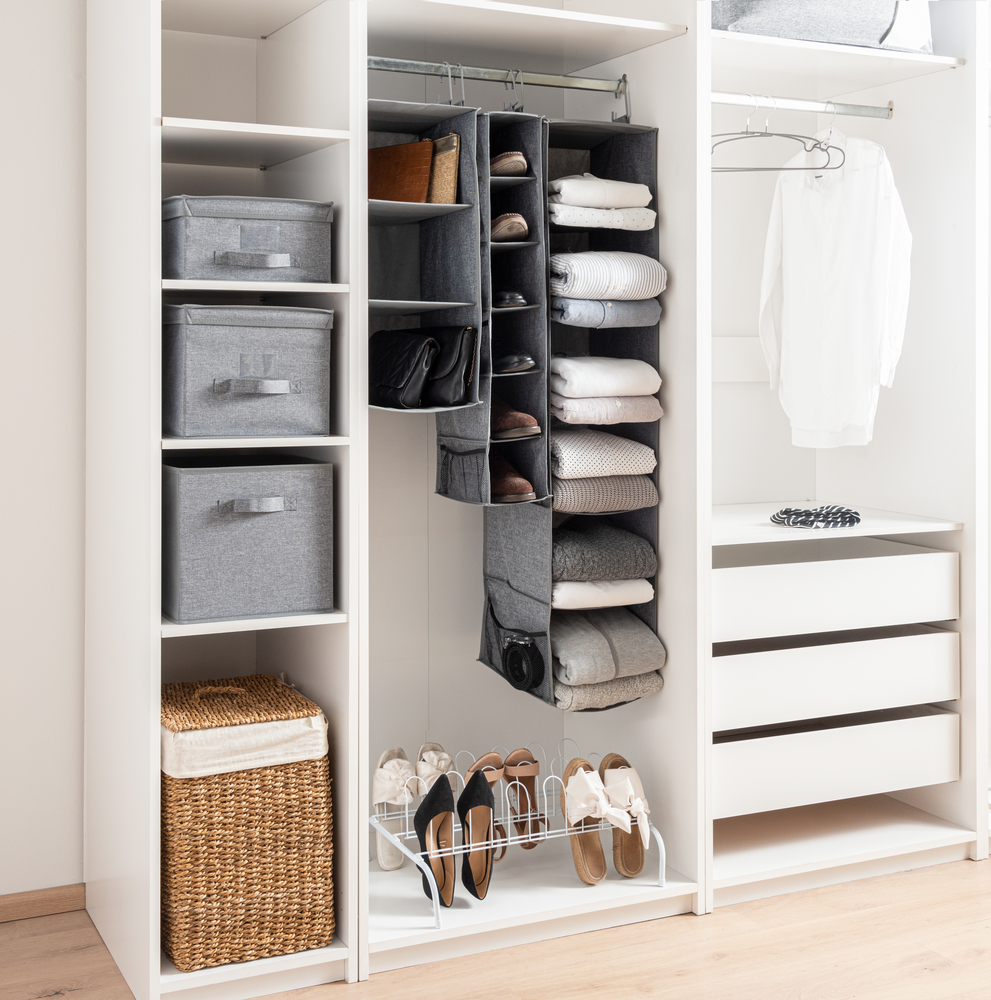 white closet organizer with hanging sweater storage 