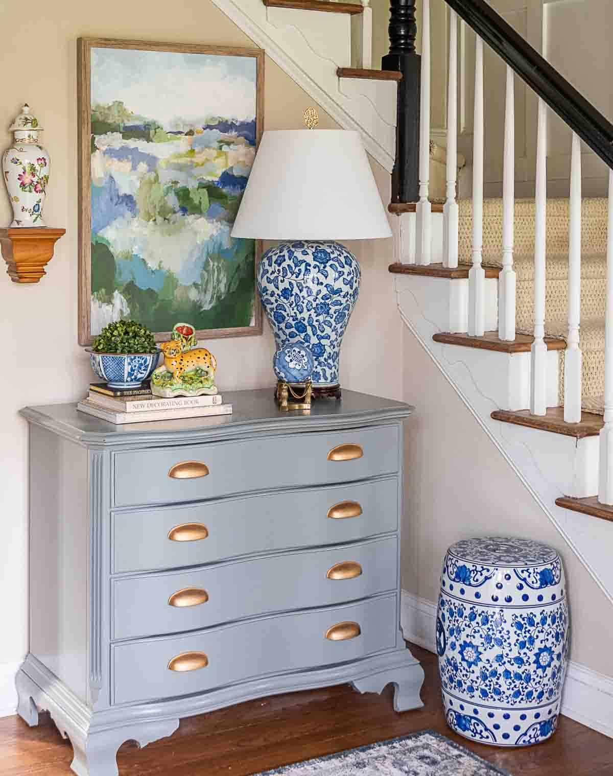 gray chest with blue and white lamp and traditional accessories