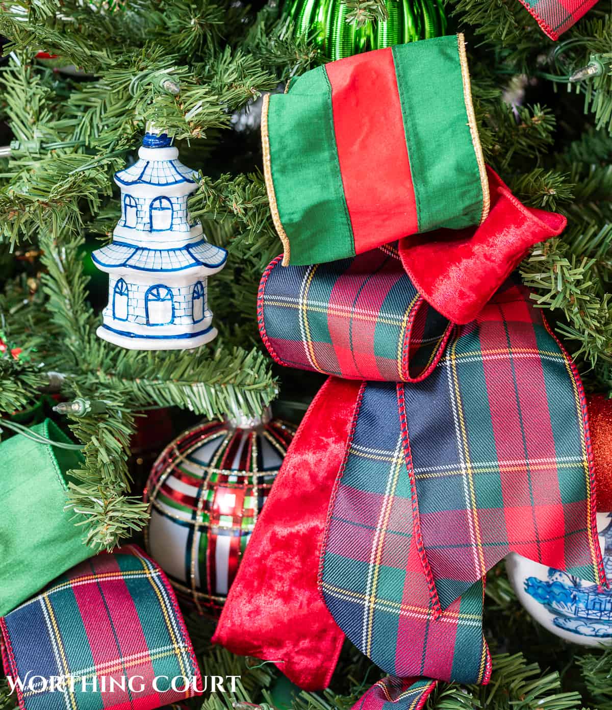 red, green and blue and white traditional decorations on a Christmas tree