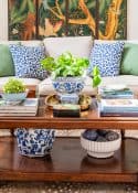 a variety of colorful accessories on a coffee table in front of a beige sofa in a new traditional style living room