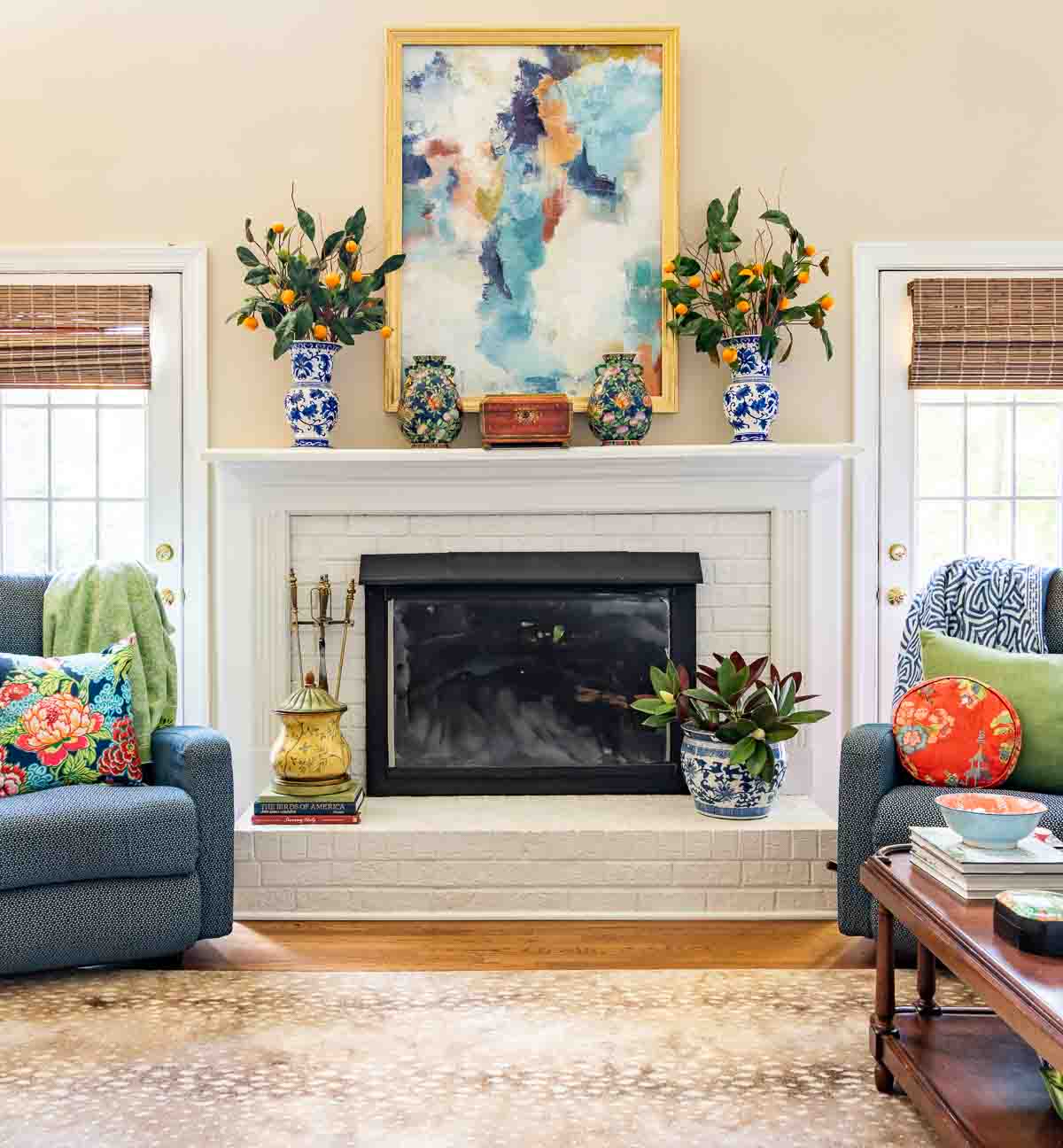 white brick fireplace decorated for summer flanked by blue recliners