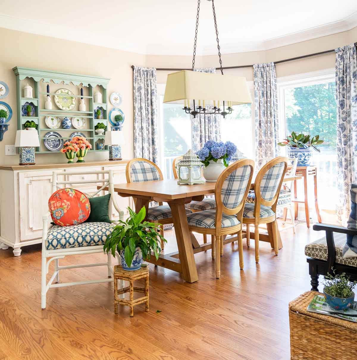 breakfast room with a large bay window decorated for summer