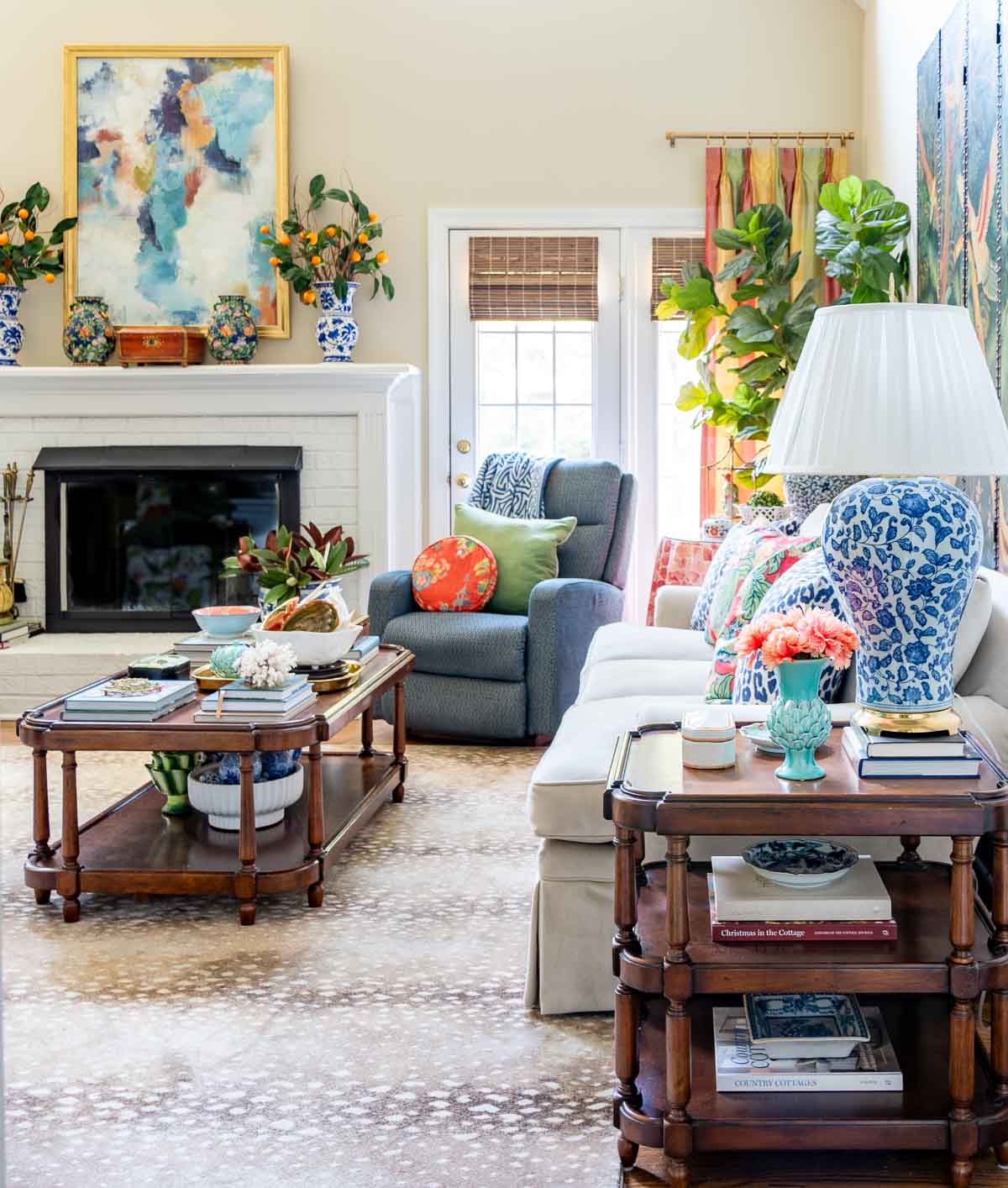 traditional style living room with colorful accessories, a blue armchair and a neutral sofa