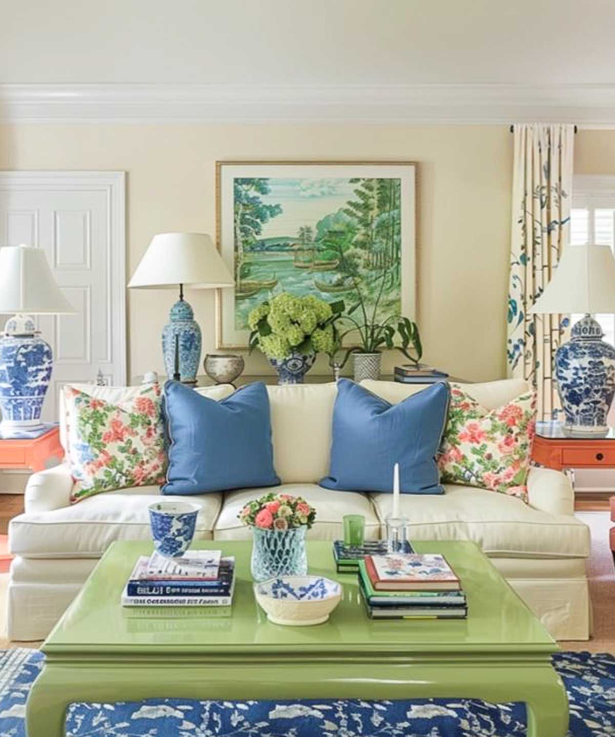 a traditionally furnished living room with a color palette of blue and white with coral accents