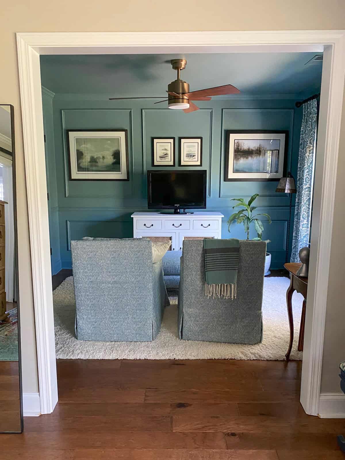 small tv room with slate blue walls