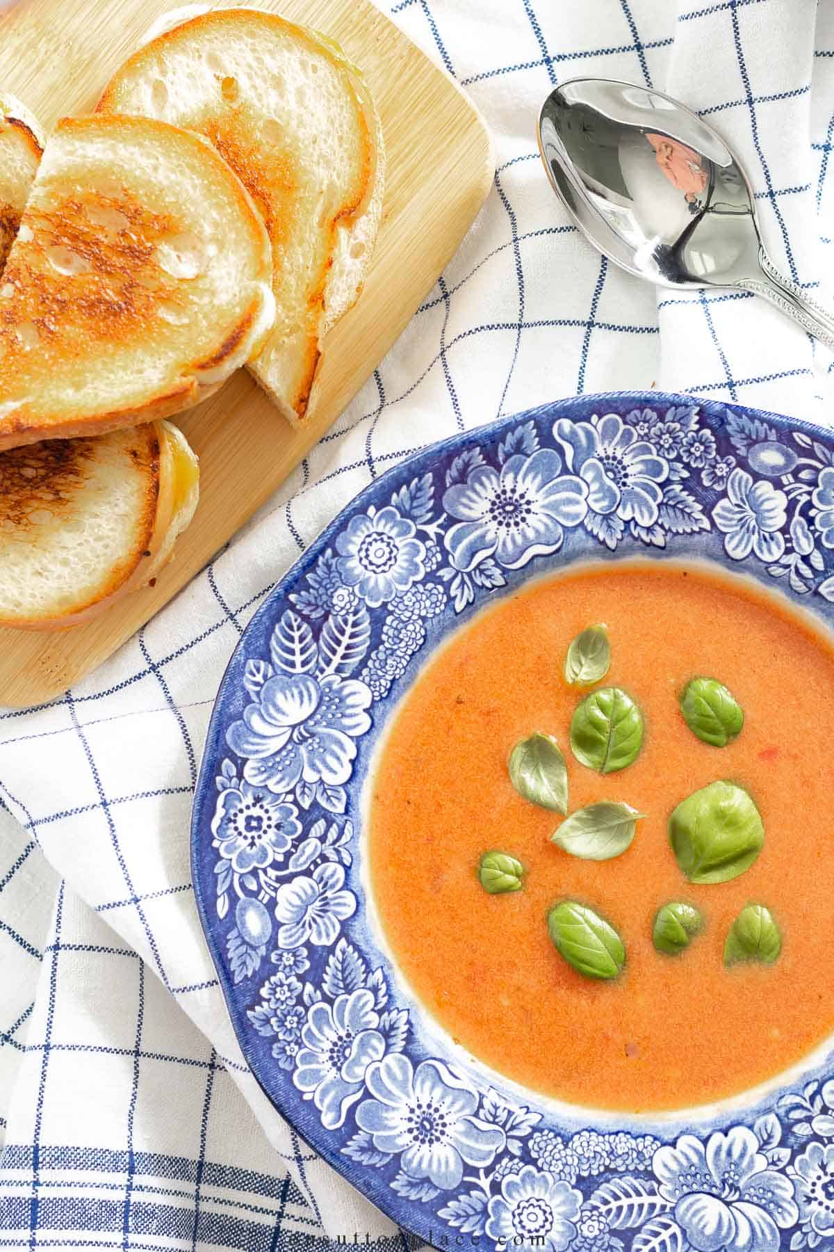 tomato soup in a blue and white rimmed soup bowl