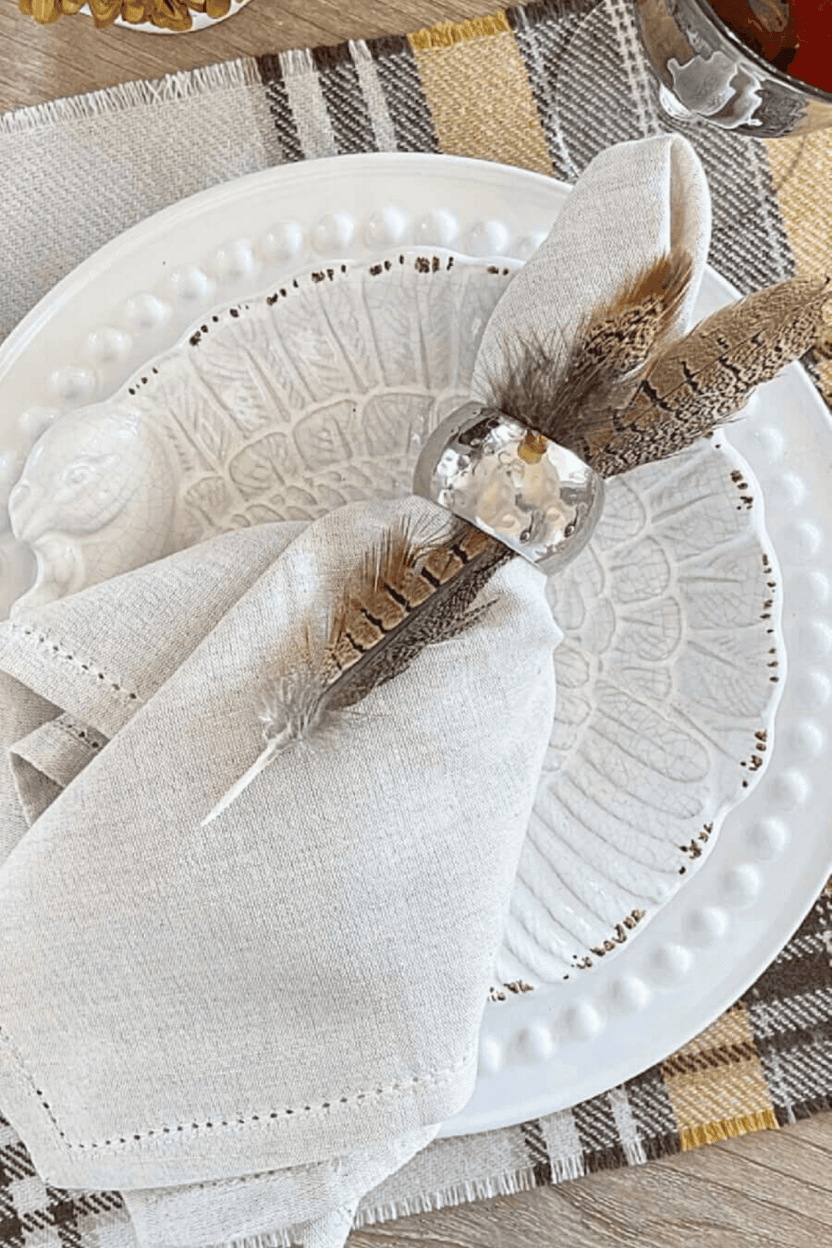 place setting with a white napkins and white stacked plates