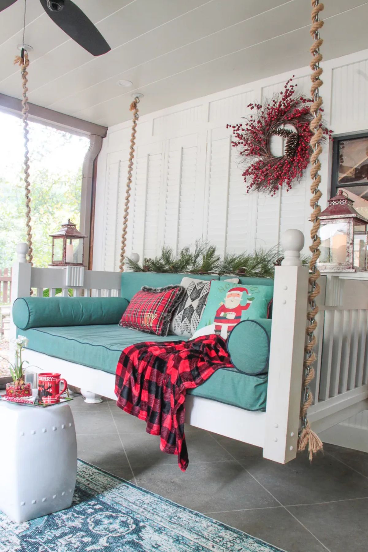 porch swing with teal cushions