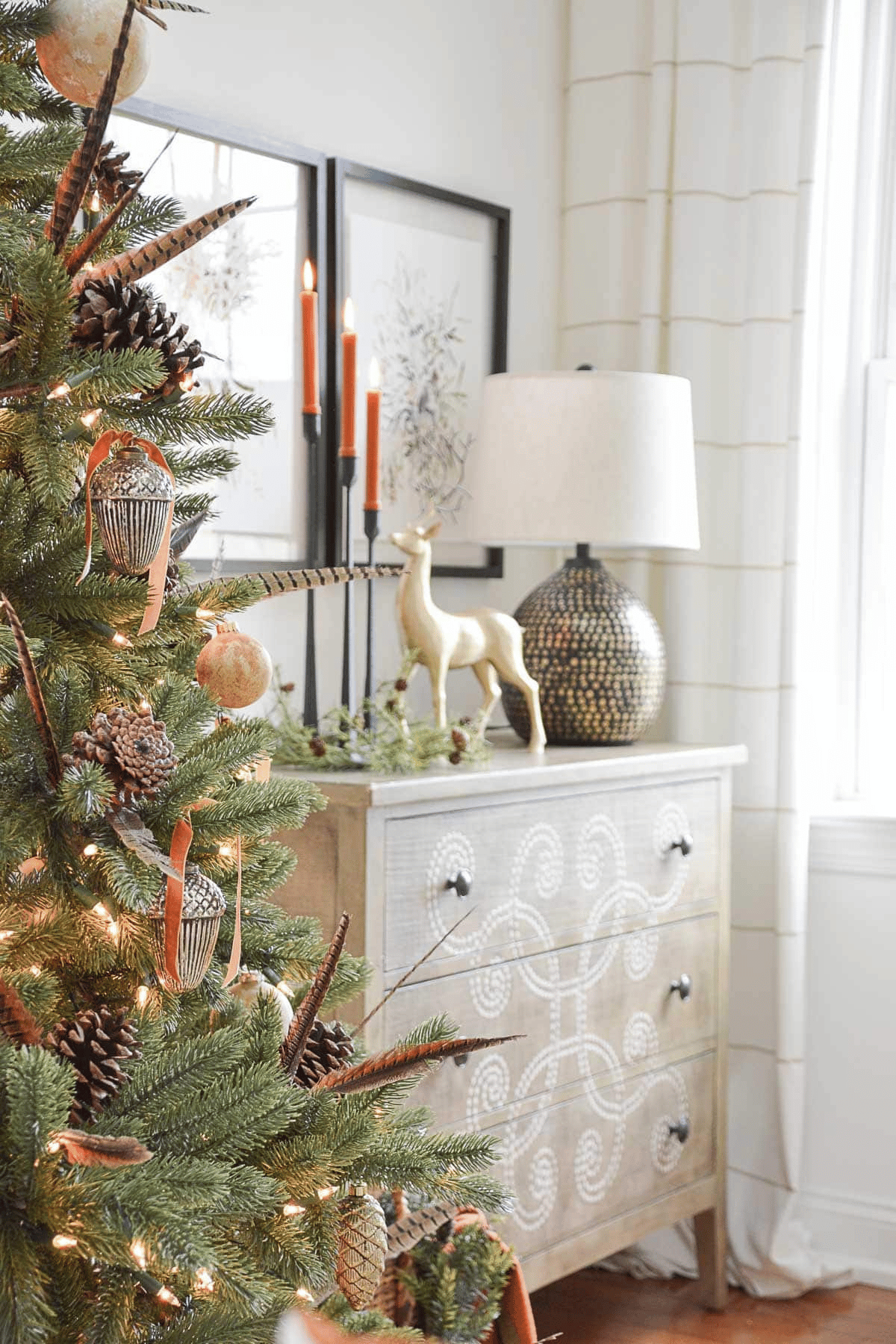 partial view of a Christmas tree beside a white chest