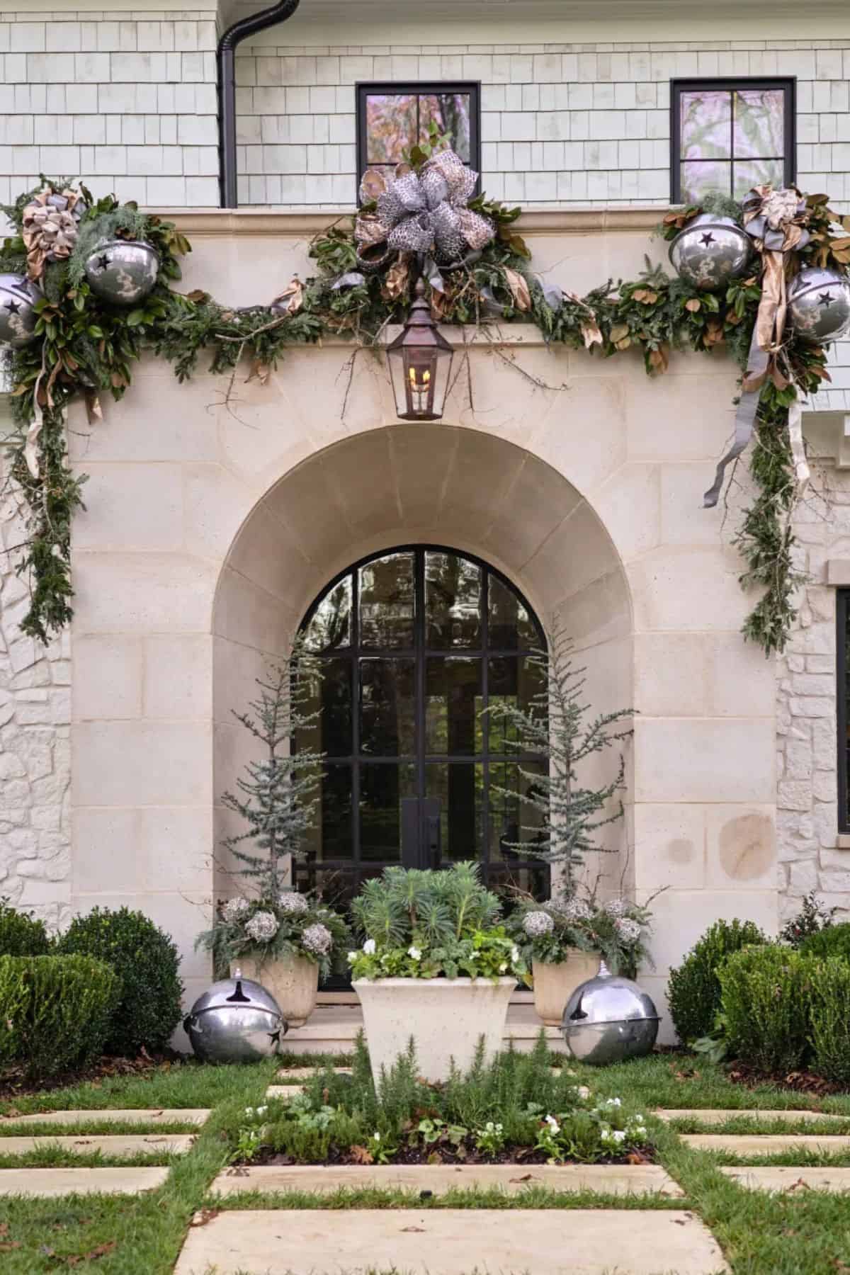 front entrance to a large home decorated for the holidays