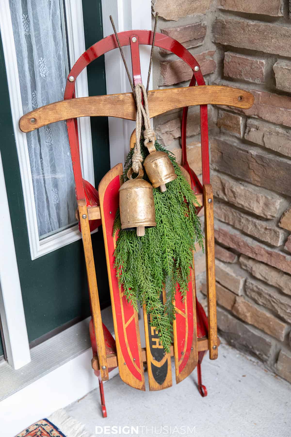 vintage sled leaning against a wall on a porch