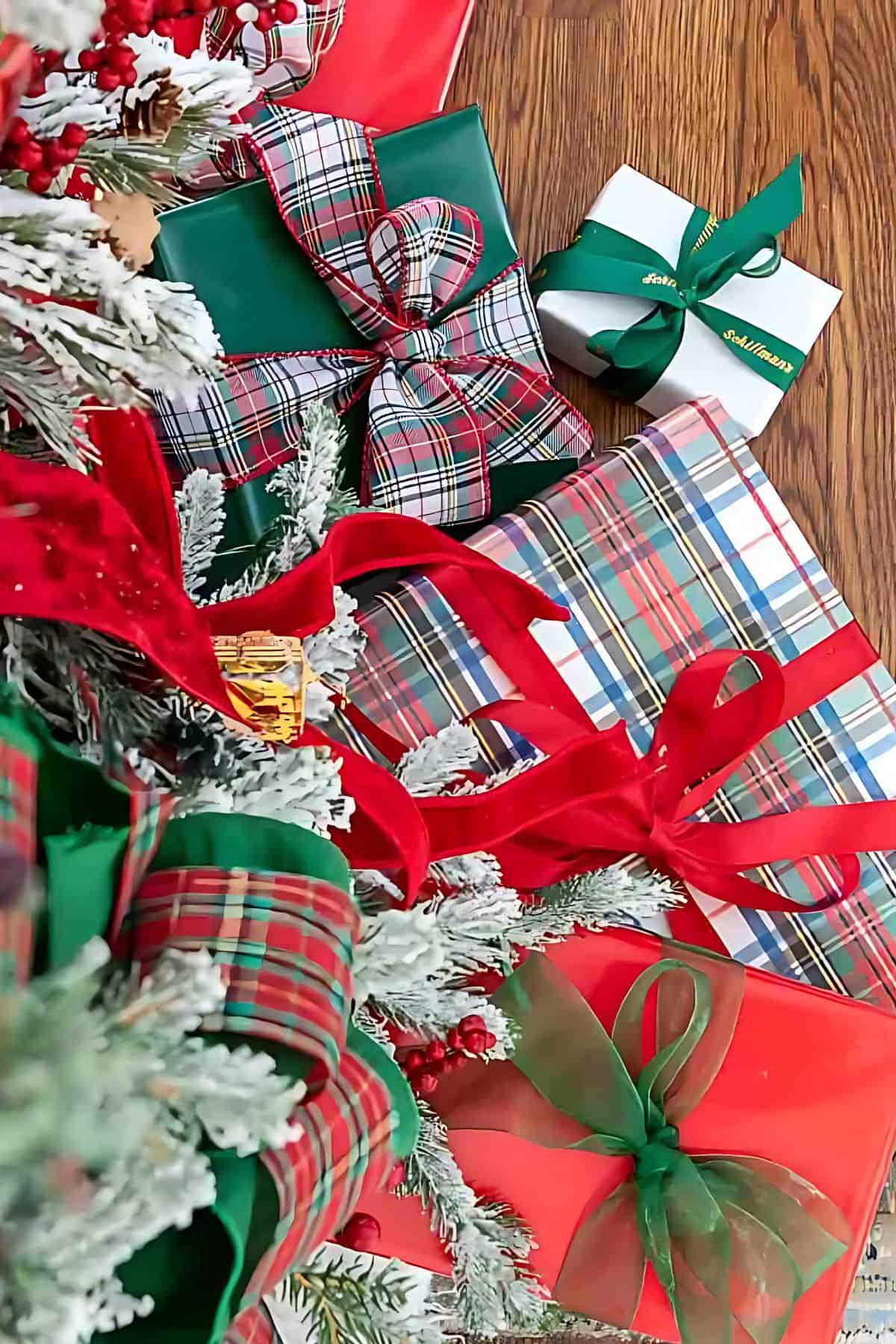 overhead view of gifts under a tree wrapped with plaid paper