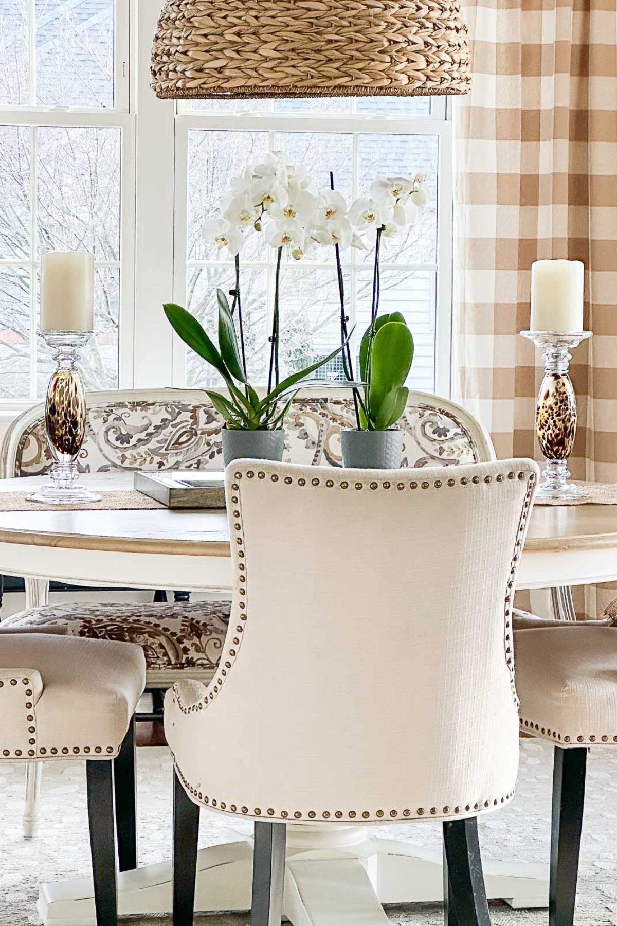 neutral upholstered chairs at a dining table