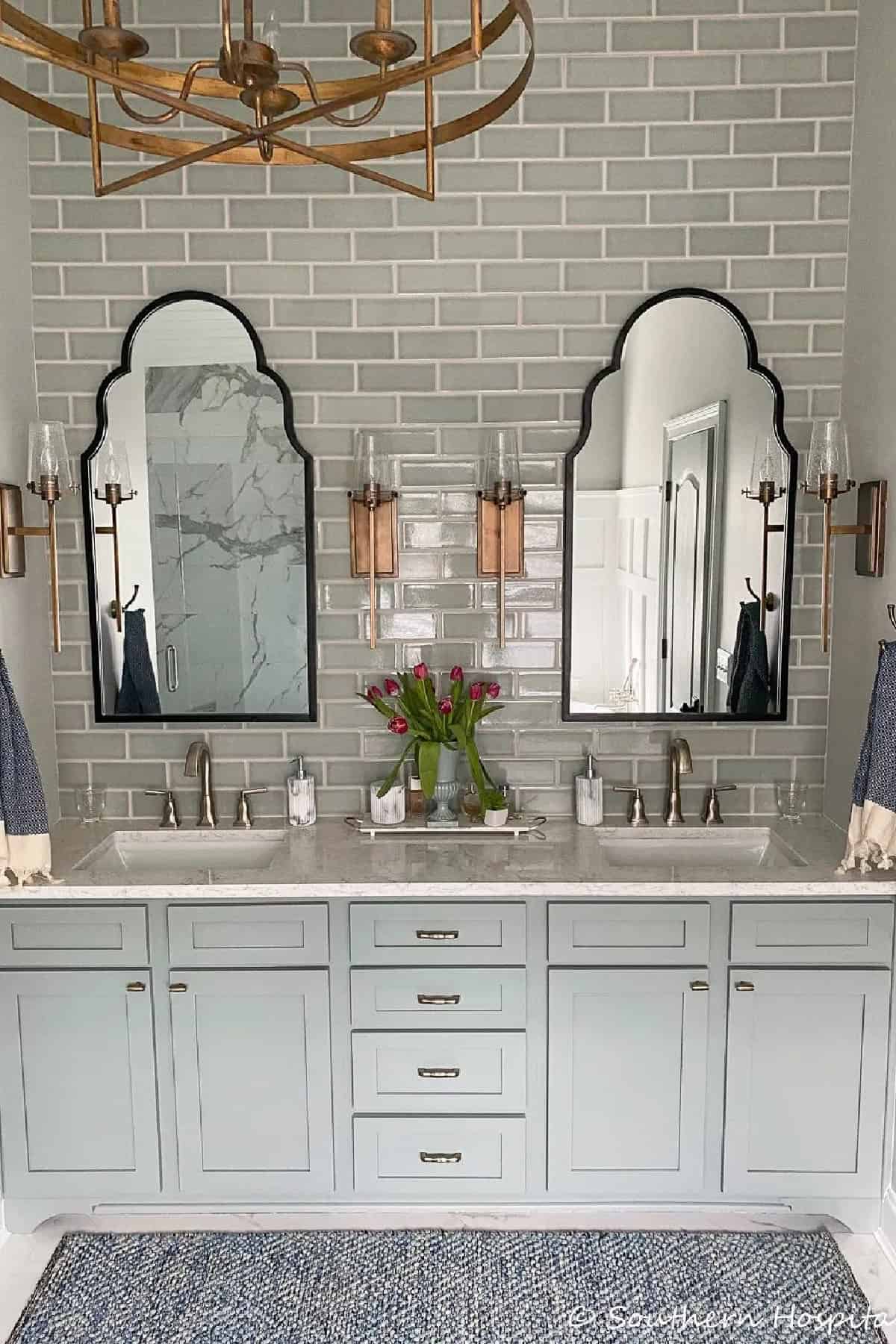 bathroom vanity with two arched mirrors above