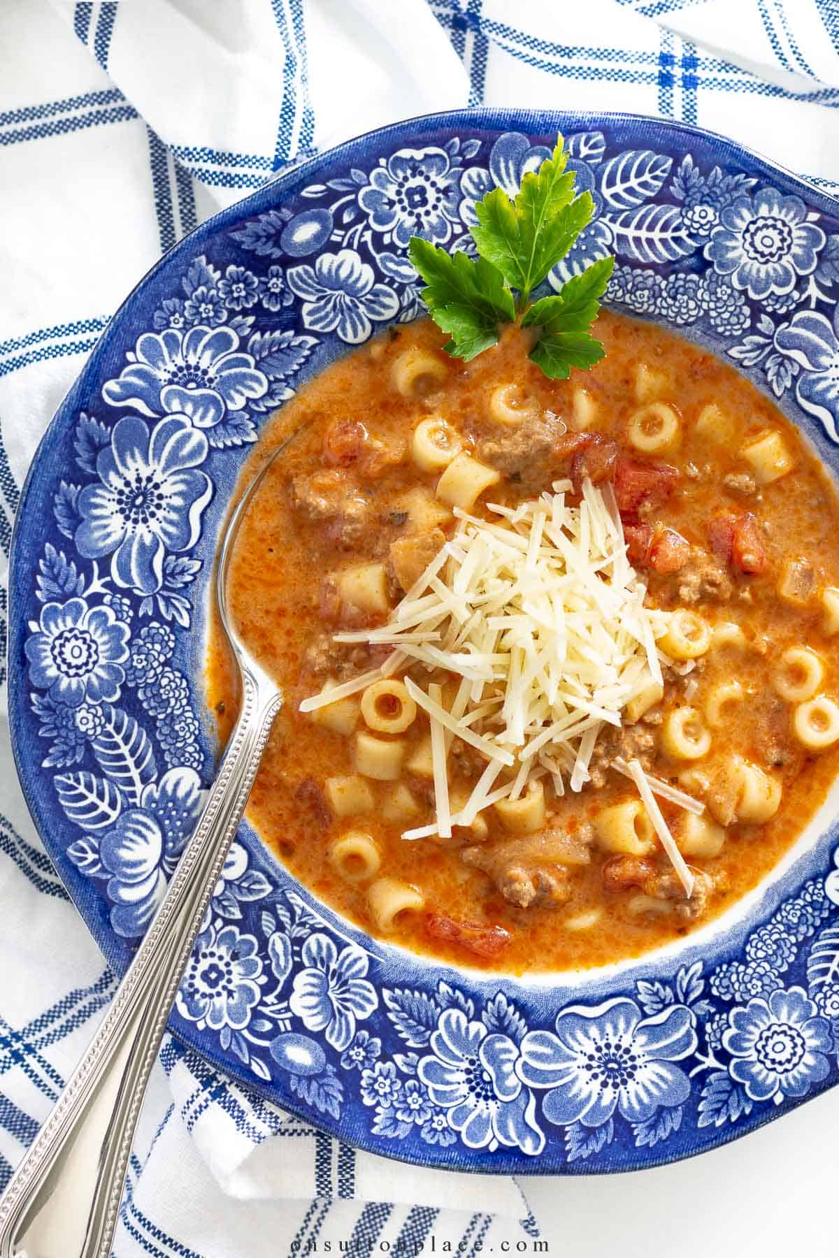 spaghetti soup in a bowl with a blue rim