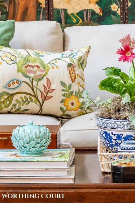 partial view of a colorful spring vignette on a coffee table