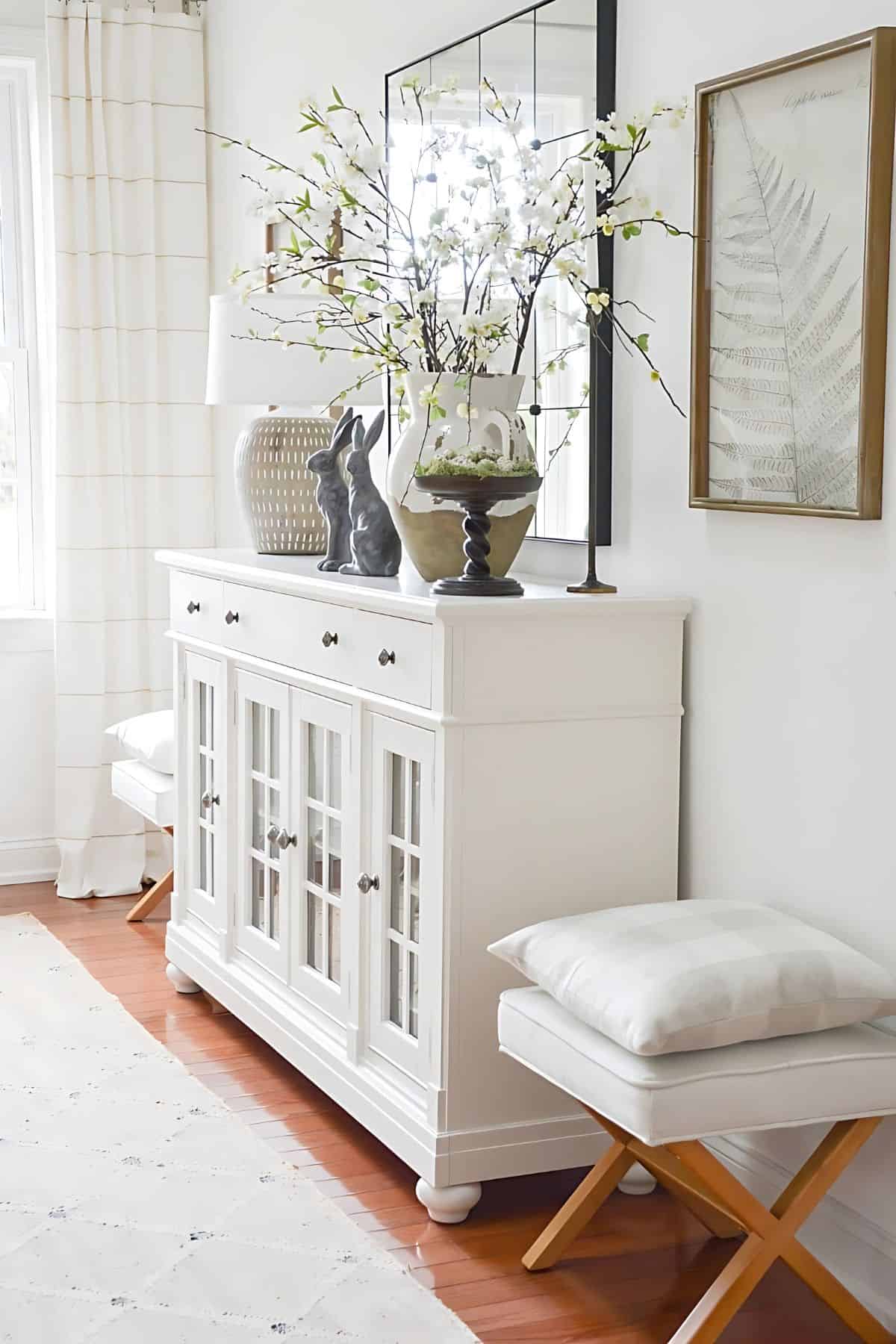 white console table with neutral decorations in a neutral living room