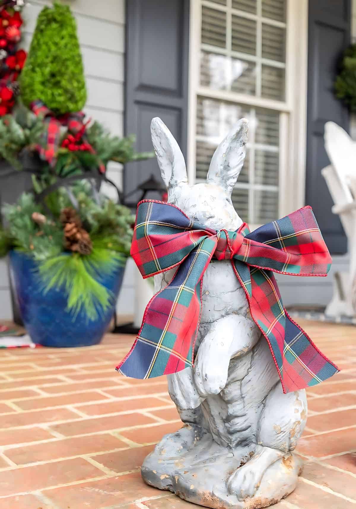 concrete bunny with a Christmas ribbon bow