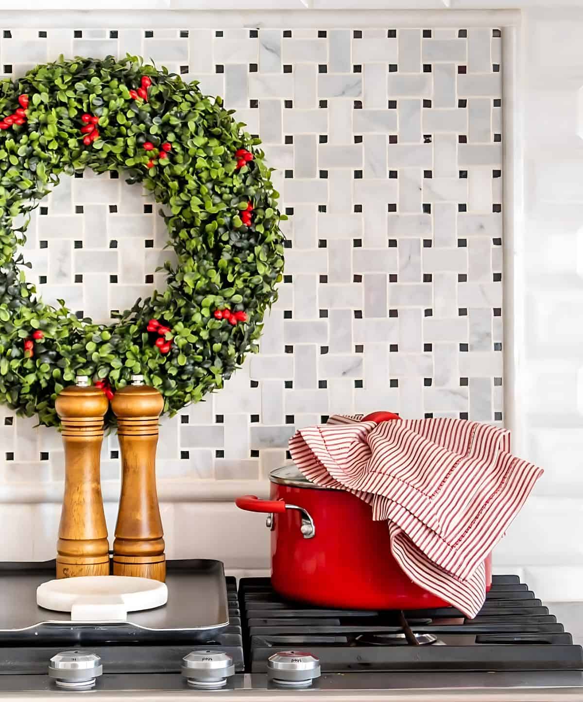 red cooking pot and Christmas decor on a stove top