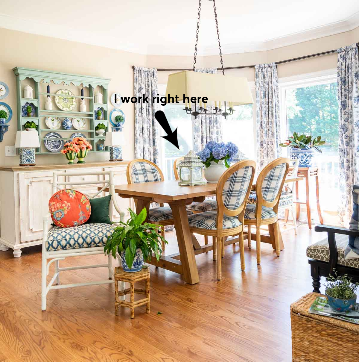 breakfast room with a large bay window decorated with blue and white cottage style furniture and decor