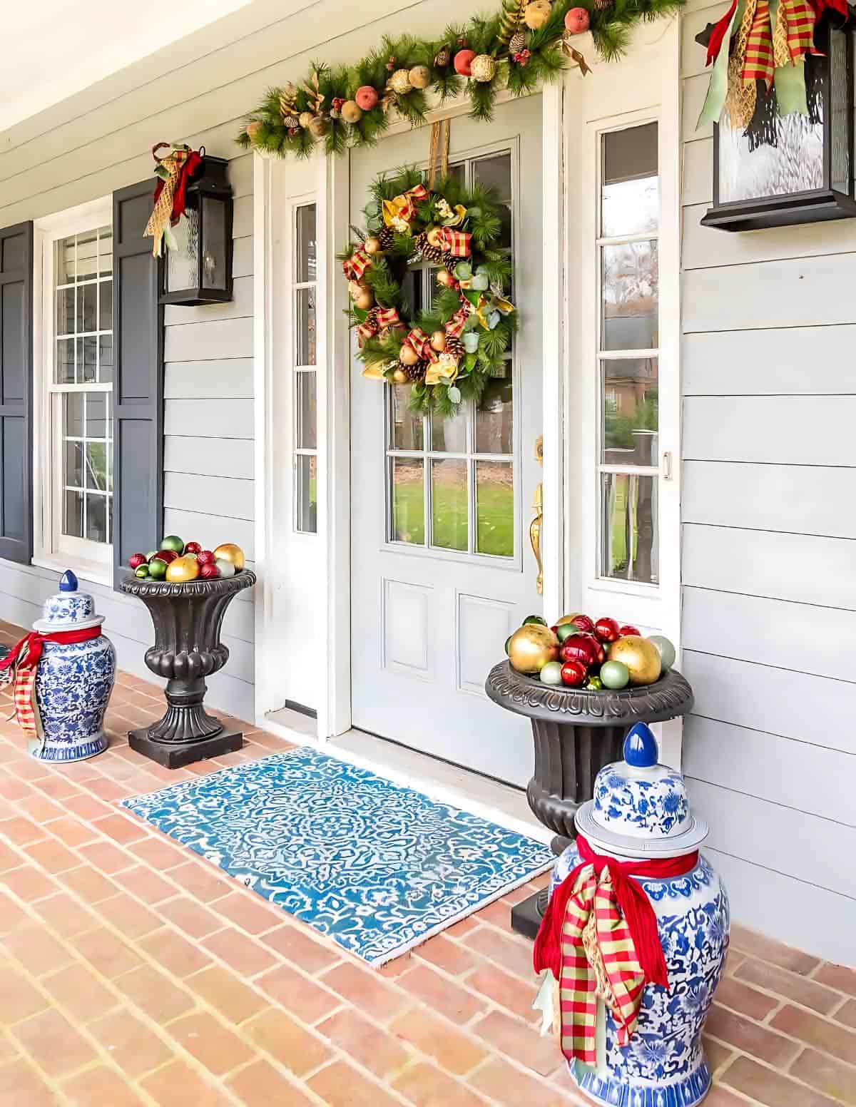 front porch on a gray house decorated for Christmas