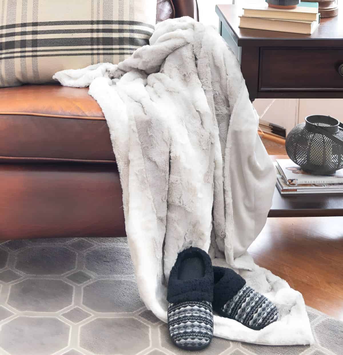 faux fur blanket draped over a brown leather chair