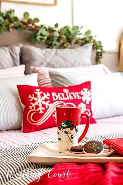 merry Christmas red pillow on a bed