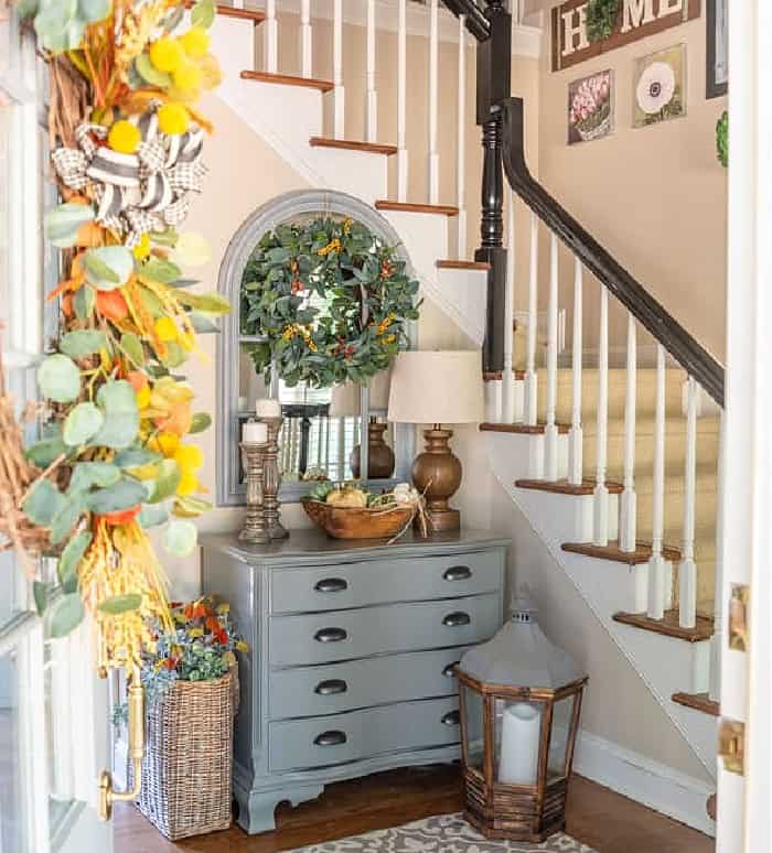 foyer with a gray chest decorated for fall