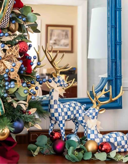 pair of blue and white checked deer beside Christmas tree