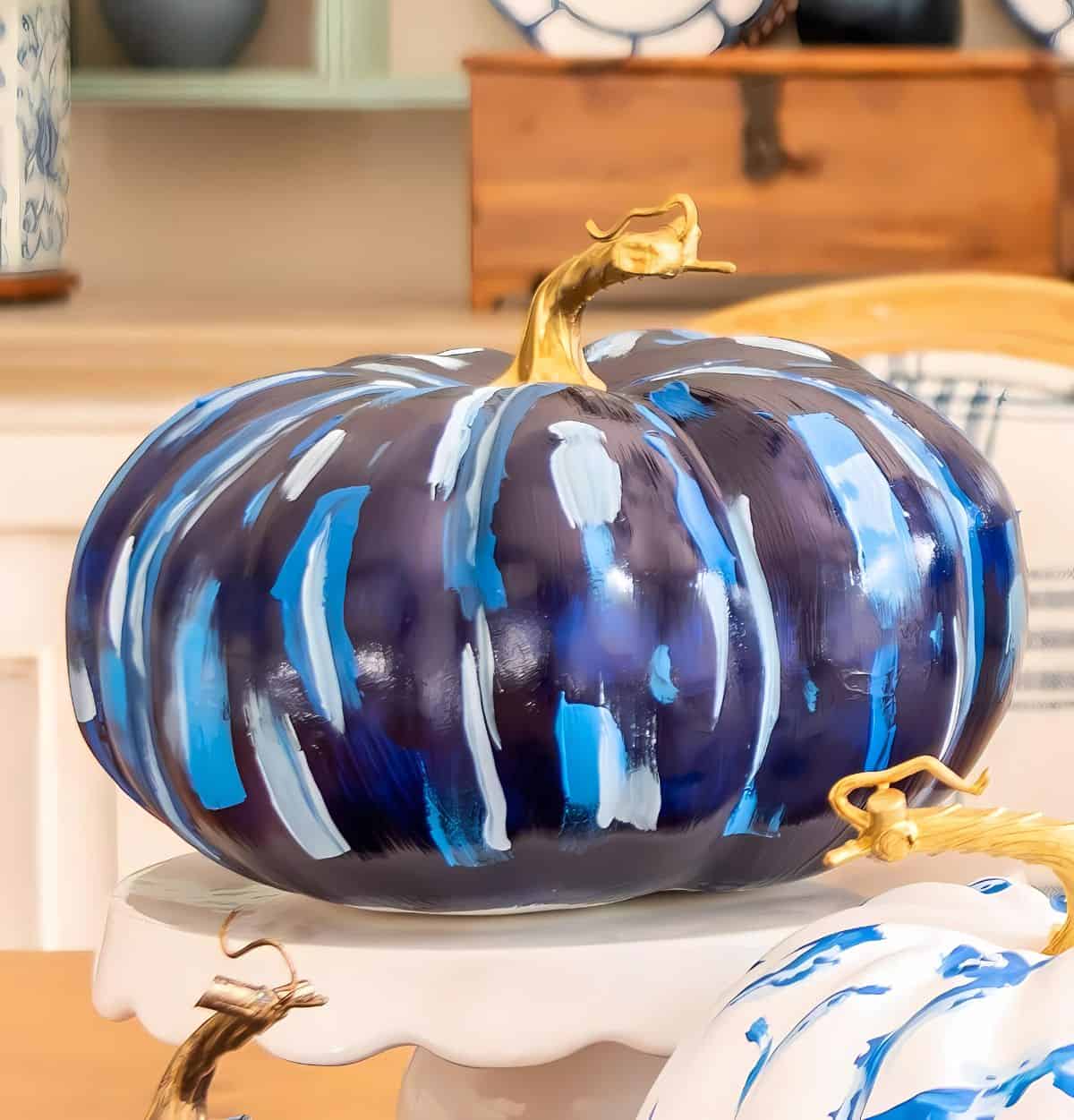 blue and white DIY painted pumpkins used as a centerpiece