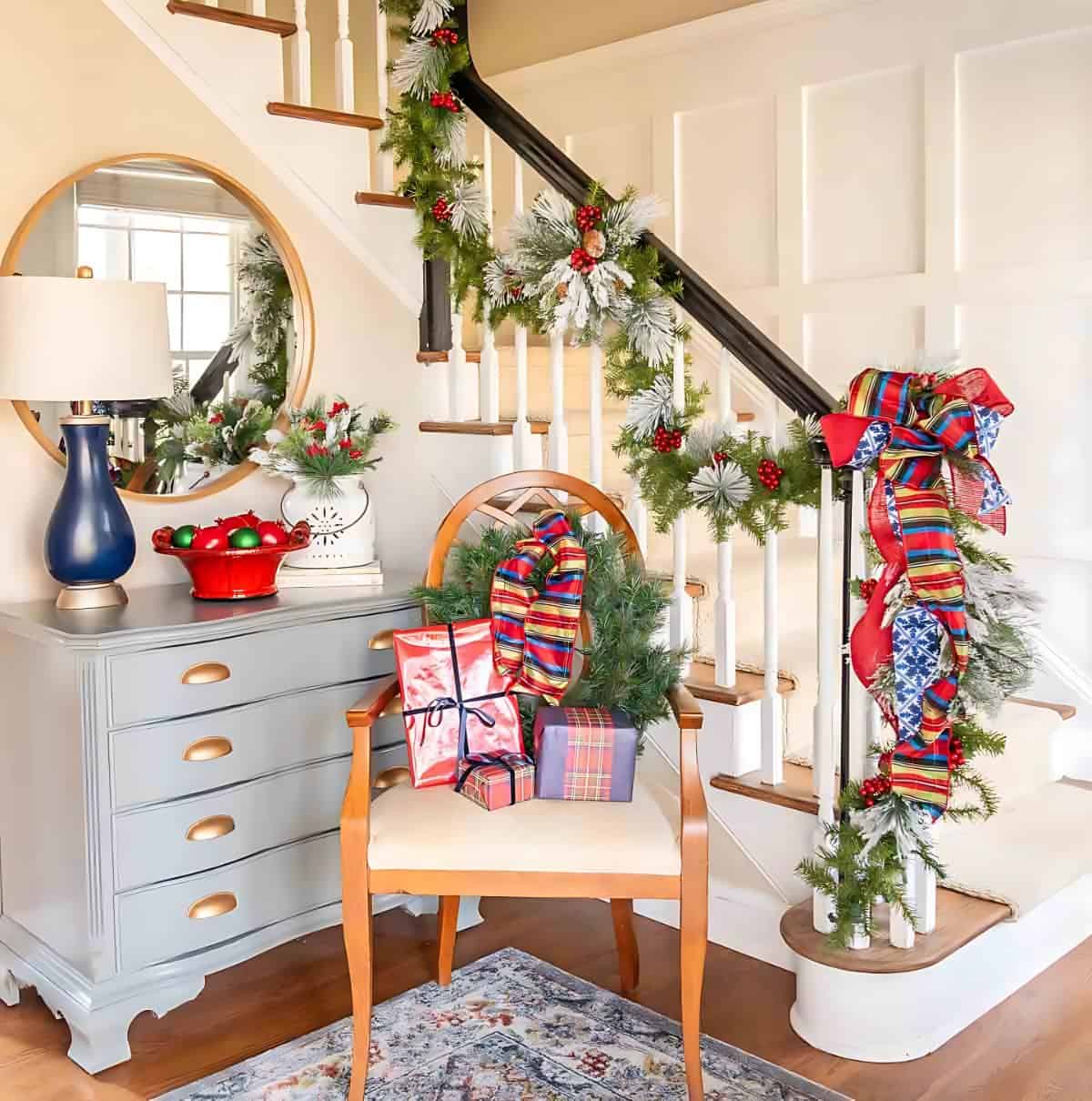 foyer decorated for Christmas with garland and blue and green ribbon