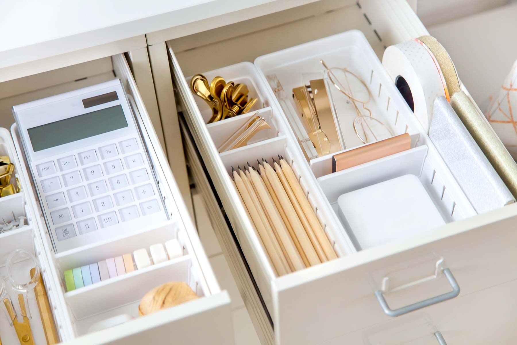 office supplies in an organizer tray in a drawer